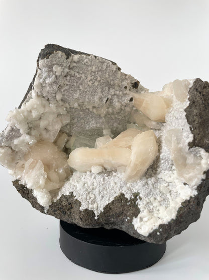 A close-up of a large Heulandite cluster with well-defined peach Stilbite and green Apophyllite crystals.