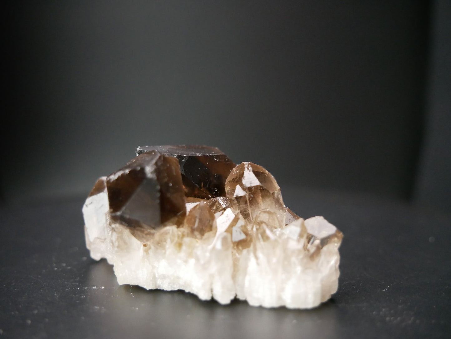 Close-up image of a Smokey Quartz Crystal Cluster weighing 69.39 grams, showcasing its intricate natural formations and earthy hues.