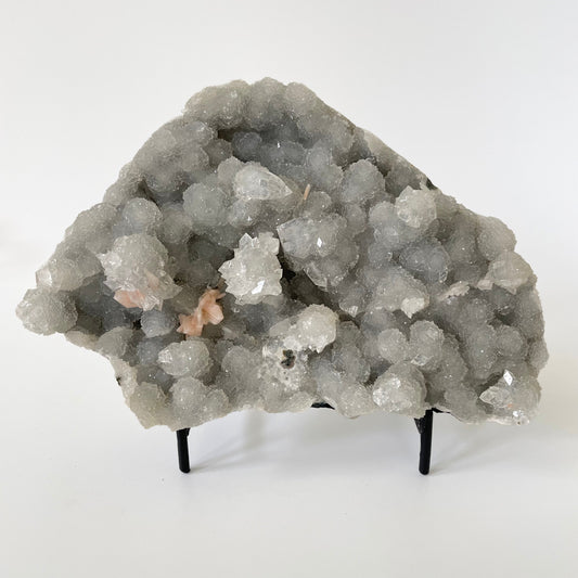 A rare 4.5-inch blue chalcedony cluster with soft blue hues on a white background. It has accents of stilbite and apophyllite crystal formations.