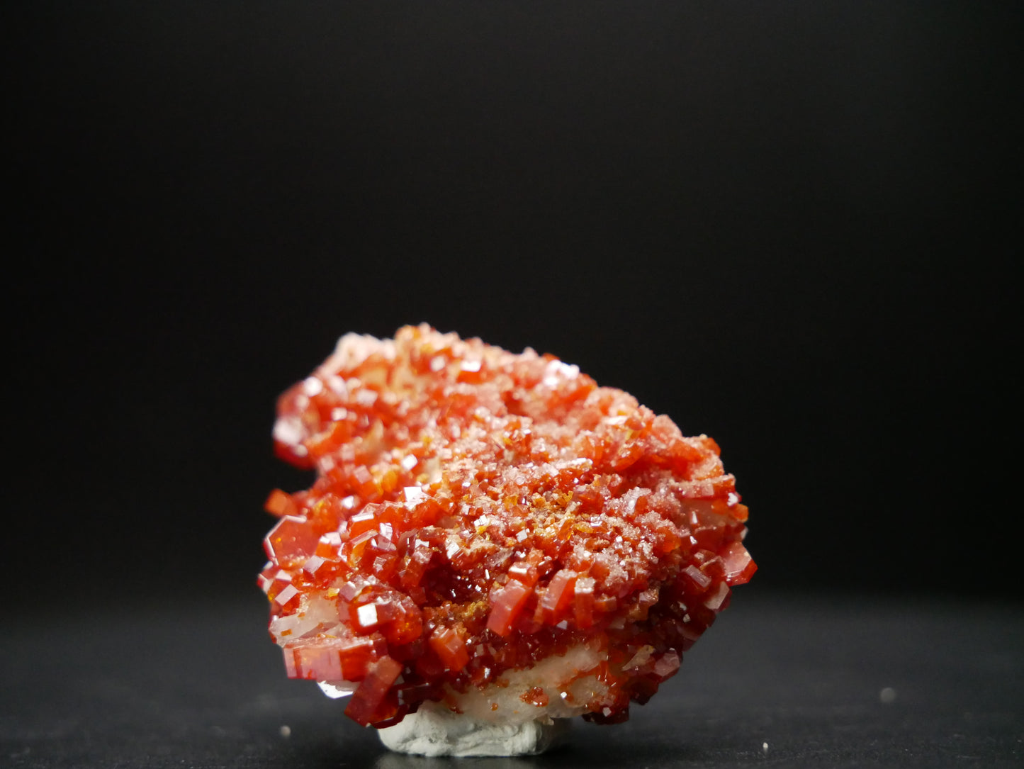 Vanadinite Crystal Specimen on Matrix from Morocco, weighing 30.9 grams. A cluster of vibrant red-orange vanadinite crystals nestled on a natural matrix, showcasing the unique beauty of this mineral specimen.